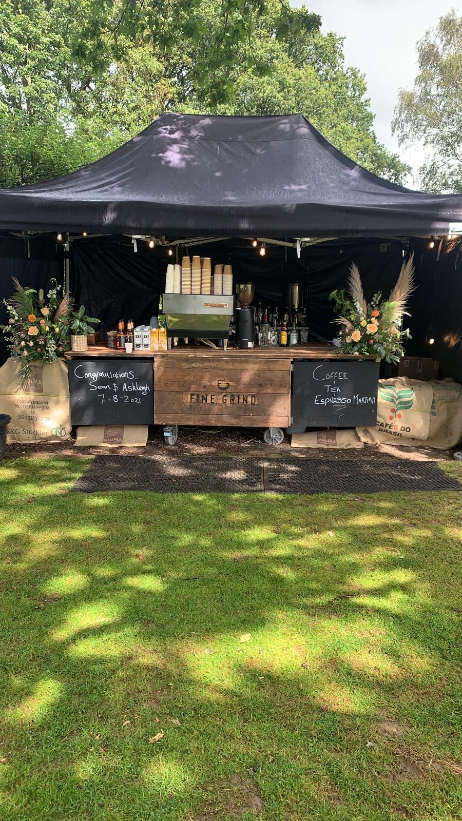 Fine Grind wedding bar dressed with flowers and custom congratulations signage