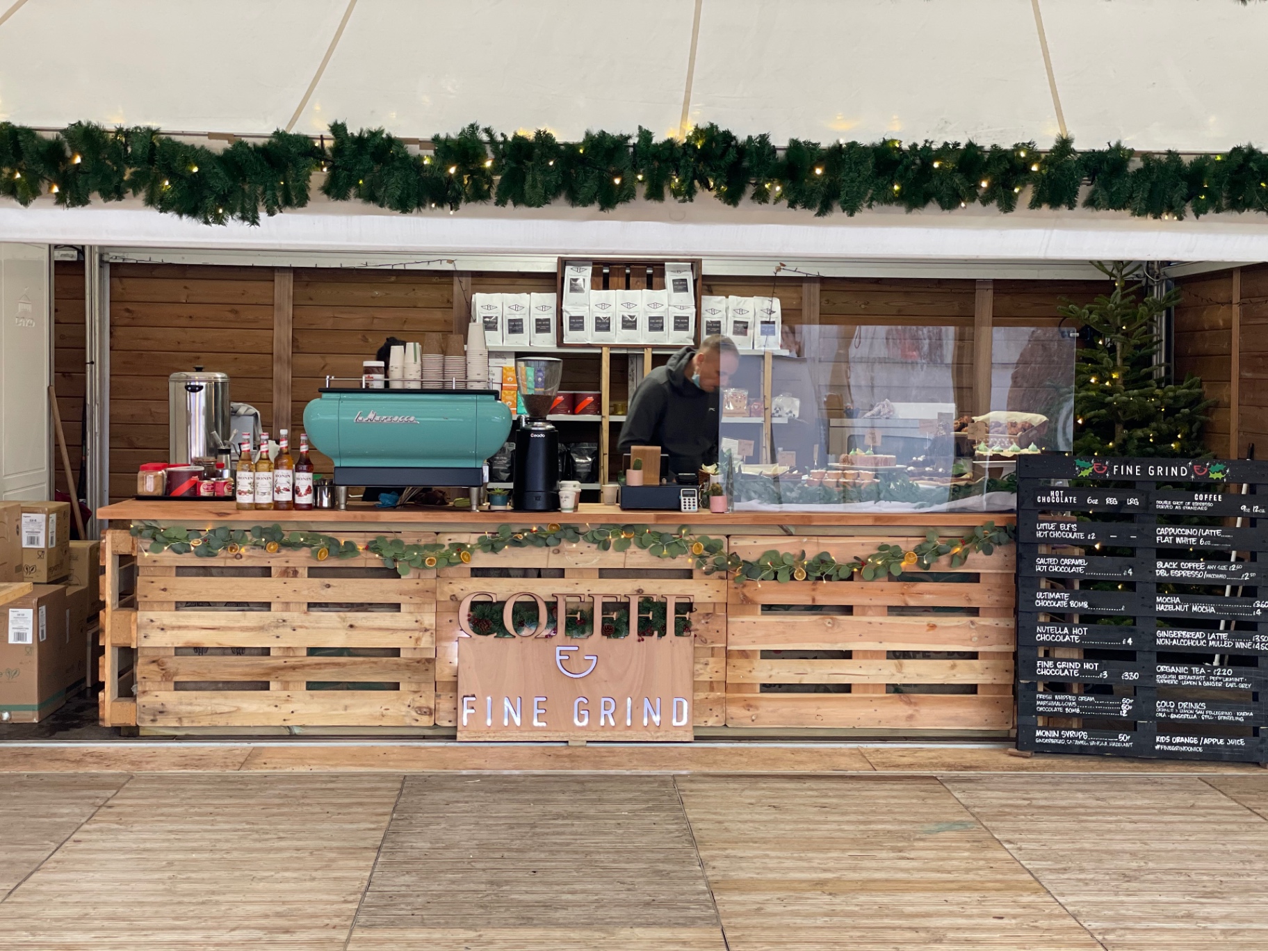 Fine Grind Christmas bar with turquoise La Marzocco machine, garlands and festive drinks menu