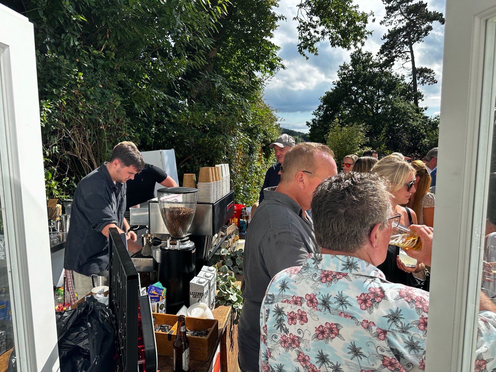 Barista pulling espresso behind the Fine Grind bar during a private garden party